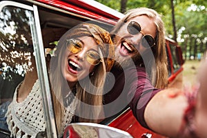 Photo of young hipsters man and woman smiling, and sitting in re