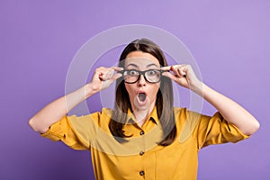 Photo of young lady hold specs open mouth wear eyewear yellow shirt isolated violet color background