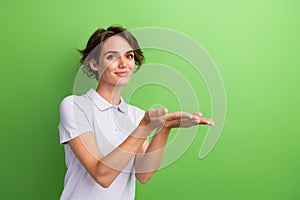 Photo of young lady purple uniform polo holding two hands demonstrating membership swimming pool offer isolated on green