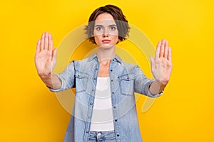 Photo of young lady show palms no refuse rejection sign enough isolated over yellow color background
