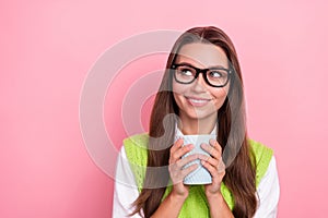 Photo of young lovely positive business woman wear green vest looking empty space dreamy mug tea menu cafeteria isolated