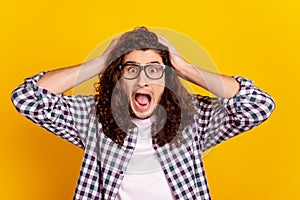 Photo of young man hands touch chead amazed scream shoc afraid scared isolated over yellow color background