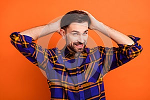 Photo of young man happy positive smile hands touch hair enjoy new haircut dander dandruff isolated over orange color