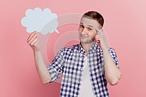 Photo of young man think deeep creative doubt hold paper cloud speech dialog isolated over pastel color background