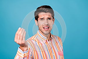 Photo of young man unhappy negative moody accuse blame ask money isolated over blue color background