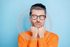 Photo of young man unhappy sad upset offended displeased look empty space isolated over blue color background