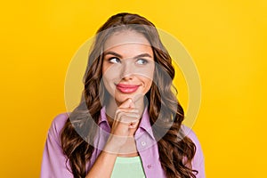 Photo of young minded dreamy woman look empty space imagine plan idea isolated on yellow color background