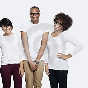 Portrait of young multi-ethnic friends in casuals smiling together over white background photo