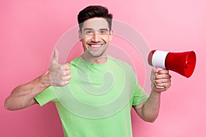 Photo of young optimistic man shows thumb up nice feedback hold loudspeaker at conference with employees isolated on