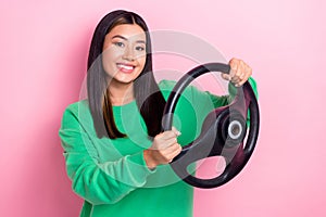 Photo of young positive experienced taxi driver chinese girl hold steering wheel new car owner automobile license