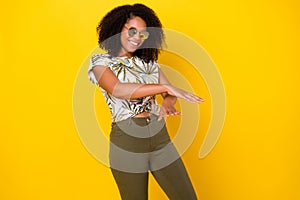 Photo of young pretty afro girl have fun dance hands party cool isolated over yellow color background