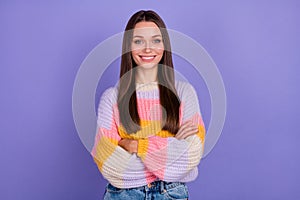 Photo of young pretty nice woman with long hair dressed oversize pullover standing hands crossed isolated on purple