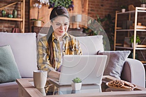 Photo of young serious charming attractive woman sit sofa remote work job programmer inside house home