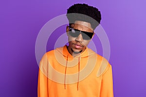 Photo of young serious dark skin cool man wear sunglass charming face youngster isolated on violet color background