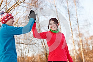 Photo of young sportsmen doing handshake in winter park at afternoon