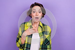 Photo of young stupor woman staring hand chest shock impressed wear stylish shirt watch scared news isolated on purple