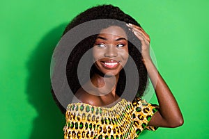 Photo of young sweet charming smiling positive african girl with perfect silky hair  on green color background