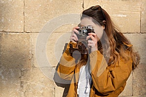 Photo of young tourist girl exploring streets of Baku. Moody photos of teenager girl visiting old city and taking photos