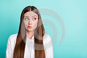 Photo of young unhappy doubtful teenager look empty space bad mood isolated on pastel teal color background