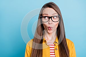 Photo of young woman amazed shocked surprised interested look empty space isolated over blue color background