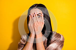 Photo of young woman cover face hands hide look afraid scared horrified isolated over yellow color background