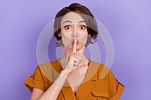 Photo of young woman cover lips finger shh keep secret confidential  over violet color background