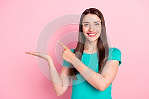 Photo of young woman happy positive point finger promo advert decision isolated over pink color background