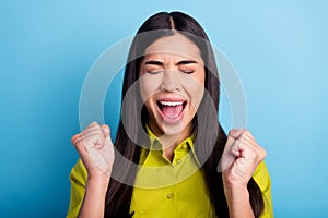 Photo of young woman happy positive smile celebrate victory fists hands ecstatic lottery isolated over blue color