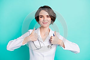 Photo of young woman happy positive smile doctor assistant show thumb-up cool perfect ad choice isolated over teal color
