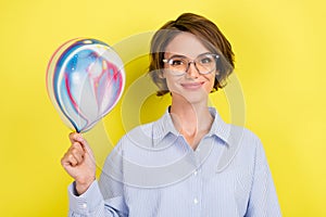 Photo of young woman happy positive smile hold air balloons decoration party isolated over yellow color background