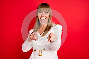 Photo of young woman happy positive smile humor joke laugh indicate fingers you isolated over red color background