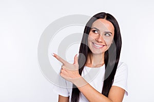 Photo of young woman happy smile look indicate finger empty space ad promo select isolated over white color background