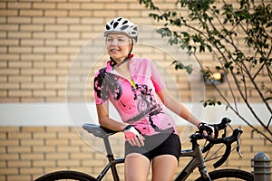 Photo of young woman in helmet on bike ride on summer day