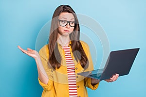 Photo of young woman hold breath cheeks uncertain questioned unsure report look laptop isolated over blue color