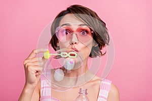Photo of young woman omg wow face reaction foam playful blow bubbles holiday isolated over pink color background