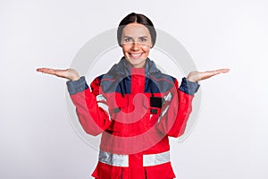 Photo of young woman paramedic happy positive smile hold hands advert pros cons solution isolated over white color
