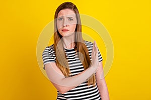 Photo of young woman show hand no stop denial signal displeased ban isolated over yellow color background