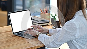 Photo of young woman typing on computer laptop .