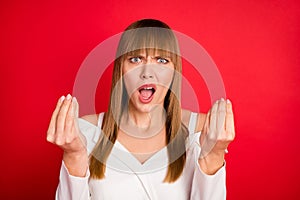 Photo of young woman unhappy negative angry mad accuse blame fail trouble isolated over red color background photo
