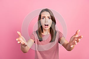 Photo of young woman unhappy shock amazed stupor panic unexpected isolated over pink color background