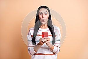 Photo of young woman use cellphone amazed shocked surprised fake novelty news rumor  over beige color background