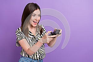 Photo of young woman wear zebra shirt hold console joystick interested look empty space mortal kombat isolated on violet