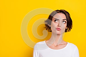 Photo of young woman wonder think look empty space uncertain minded clever isolated over yellow color background