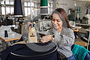 photo of a young woman working with linking machine for knitting in textile industry