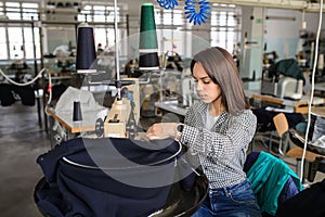 photo of a young woman working with linking machine for knitting in textile industry