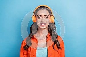 Photo of youngster confident satisfied cheerful smiling woman wear orange jacket listen new sony headphones  on