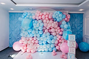 Photo zone, arch with pink and blue balloons, cubes for gender party. Boy or girl. Know gender of unborn child. Happiness of