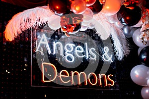 A photo zone themed angels and demons in black with white and black balls