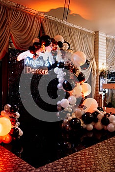 A photo zone themed angels and demons in black with white and black balls