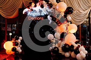 A photo zone themed angels and demons in black with white and black balls